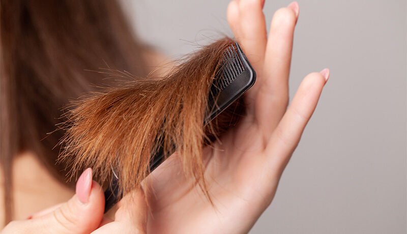 woman-combing-damaged-dry-hair-ends